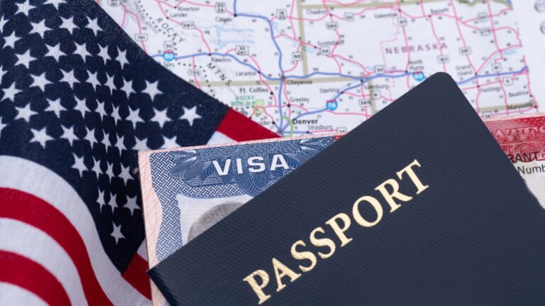Visa and passport over an American flag