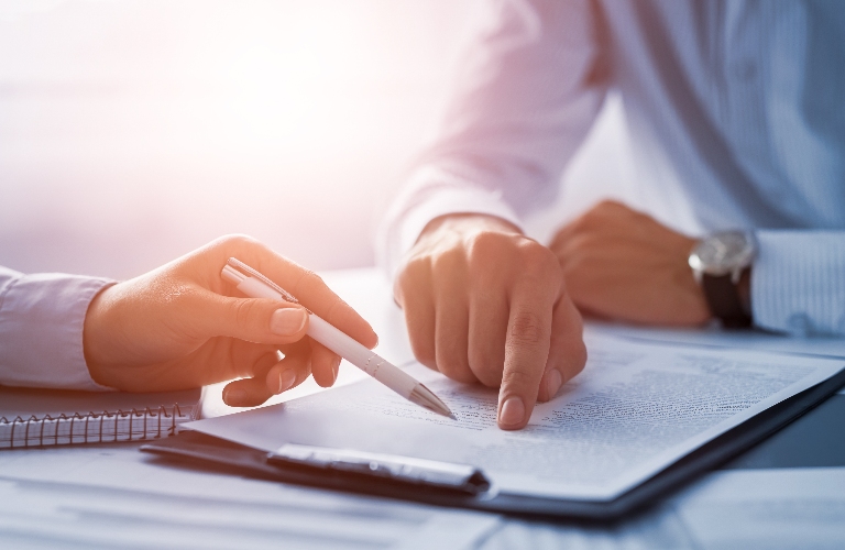 Lawyer is showing client where to sign document